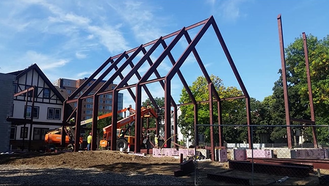 The frame for the University Lutheran Chapel in Minneapolis being built in a neighborhood